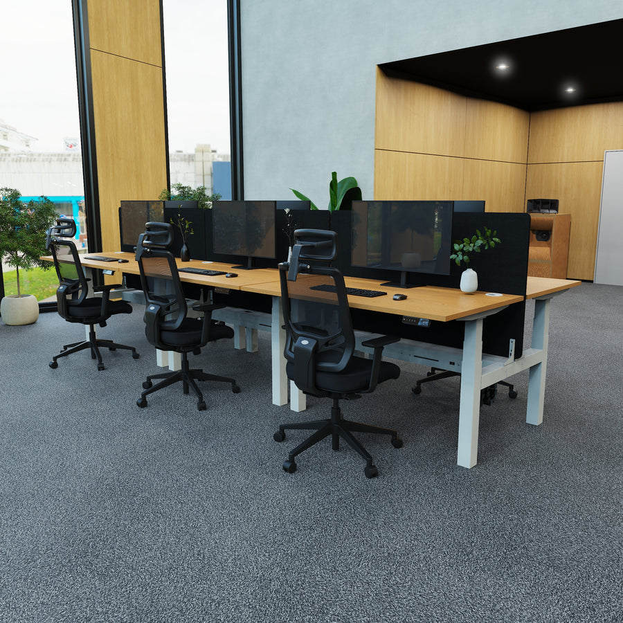 Modern office setup with desks, chairs, and computer monitors.